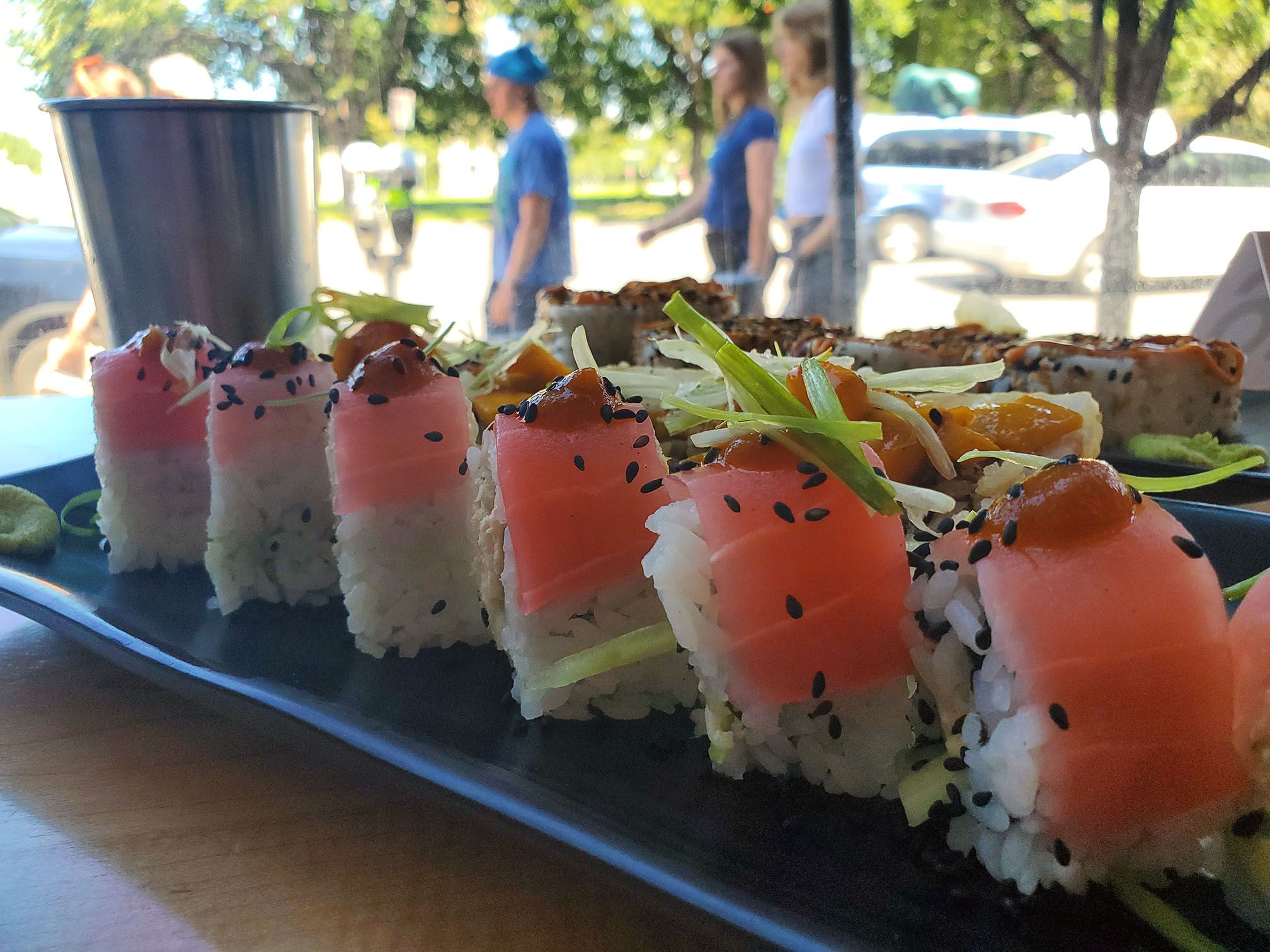 sushi role topped with pink fish